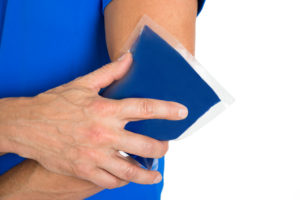 Close-up Of Hand Holding Ice Gel Pack On Elbow